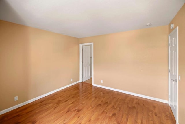 empty room with hardwood / wood-style floors