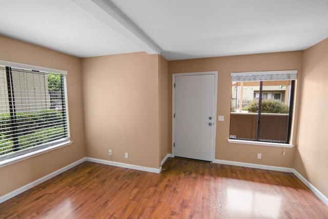 unfurnished room with dark hardwood / wood-style flooring