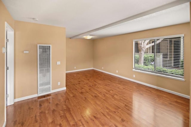 empty room with hardwood / wood-style floors