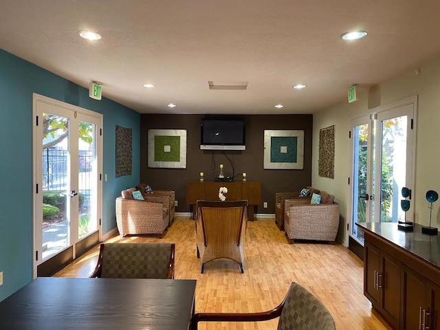 living room with light hardwood / wood-style flooring and french doors