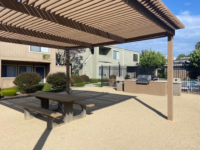 view of home's community with an outdoor kitchen and a pergola