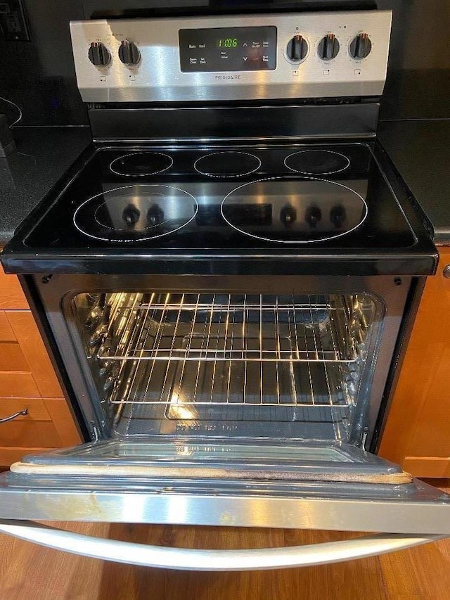 interior details with stainless steel range with electric stovetop