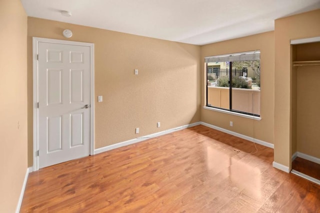 unfurnished bedroom with hardwood / wood-style flooring