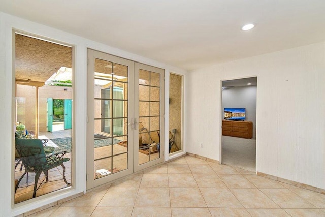 doorway with french doors and light tile patterned floors