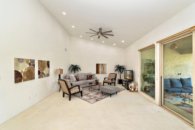 carpeted living room with ceiling fan