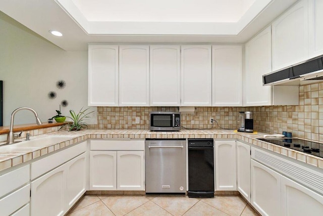 kitchen featuring sink, white cabinetry, tasteful backsplash, and light tile patterned flooring