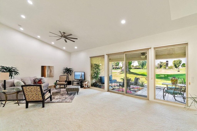 carpeted living room with ceiling fan