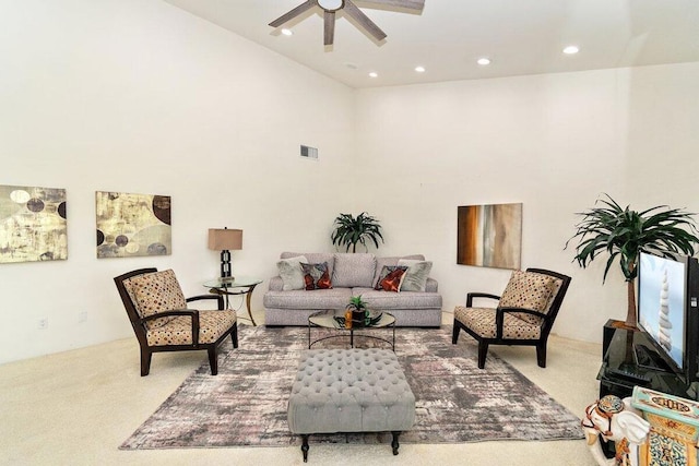 carpeted living room with ceiling fan