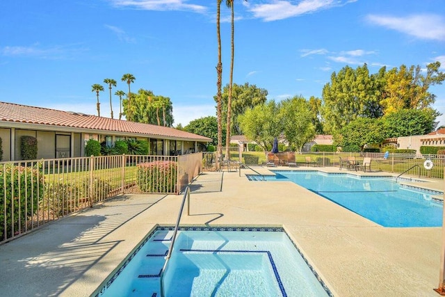 view of swimming pool featuring a community hot tub and a patio area