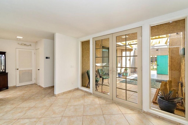 doorway featuring light tile patterned floors and french doors