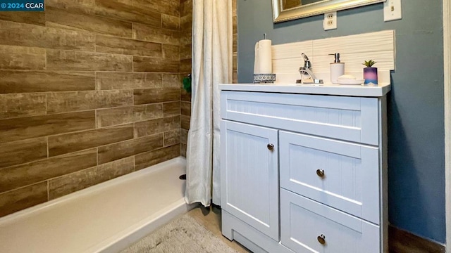 bathroom with walk in shower and vanity