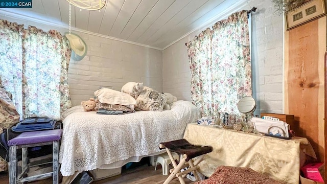 bedroom featuring ornamental molding and hardwood / wood-style flooring