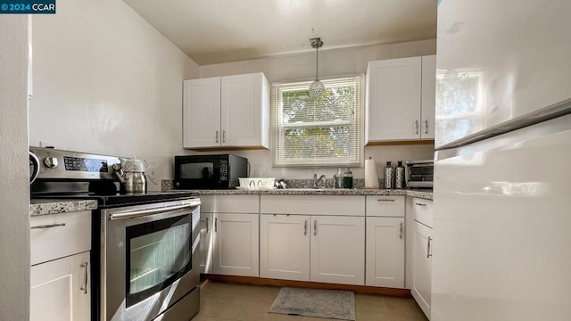 kitchen with stainless steel range with electric cooktop, white refrigerator, hanging light fixtures, and white cabinetry