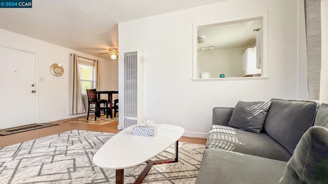 living room featuring ceiling fan and light wood-type flooring