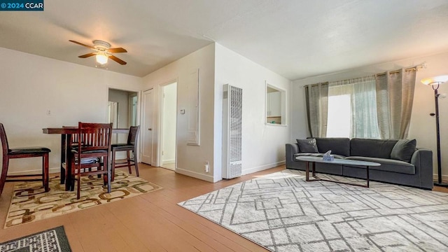 living room with light hardwood / wood-style floors and ceiling fan