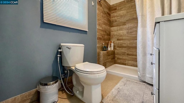 bathroom with tile patterned floors, toilet, and a shower with shower curtain