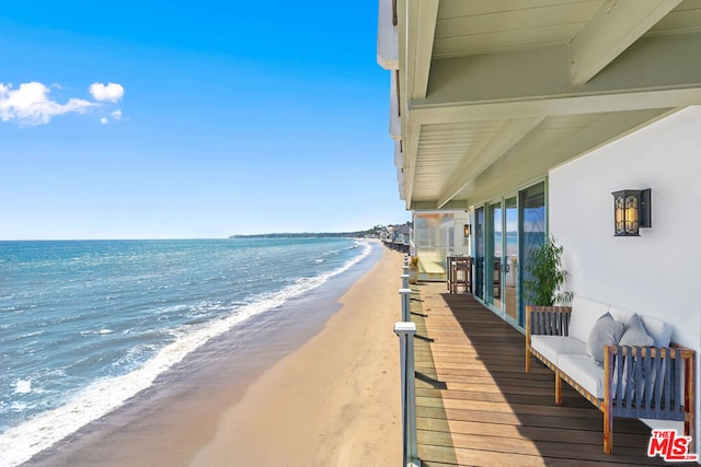 exterior space featuring a water view and a beach view