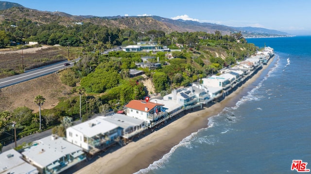 aerial view featuring a water and mountain view and a beach view