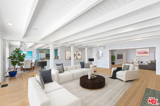 living room featuring light hardwood / wood-style flooring and beam ceiling