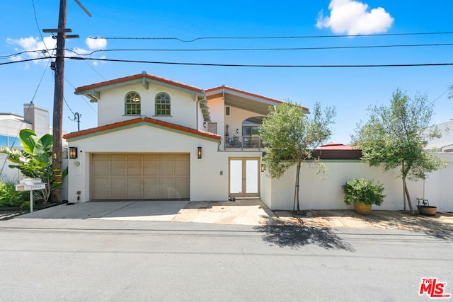 mediterranean / spanish-style house featuring a balcony and a garage