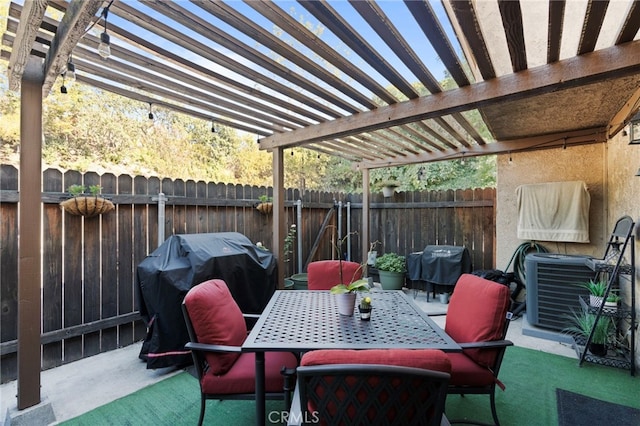 view of patio with grilling area and a pergola