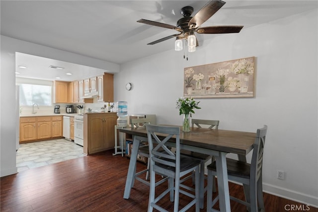 dining area with ceiling fan, hardwood / wood-style flooring, and sink