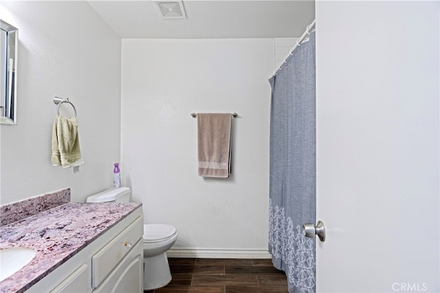 bathroom featuring a shower with curtain, hardwood / wood-style flooring, vanity, and toilet