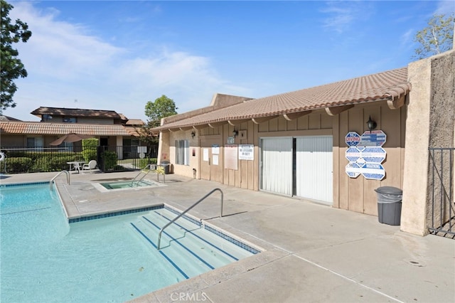 view of swimming pool with a community hot tub and a patio area