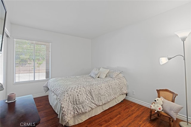 bedroom with dark wood-type flooring