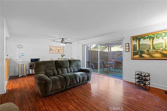 living room featuring ceiling fan and dark hardwood / wood-style floors