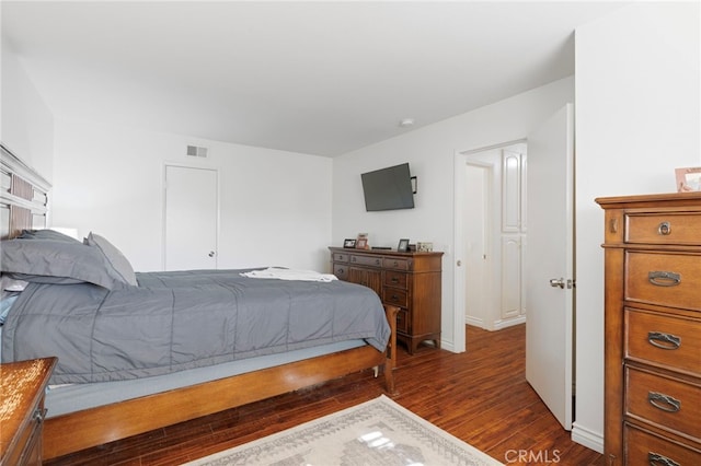 bedroom with dark hardwood / wood-style floors