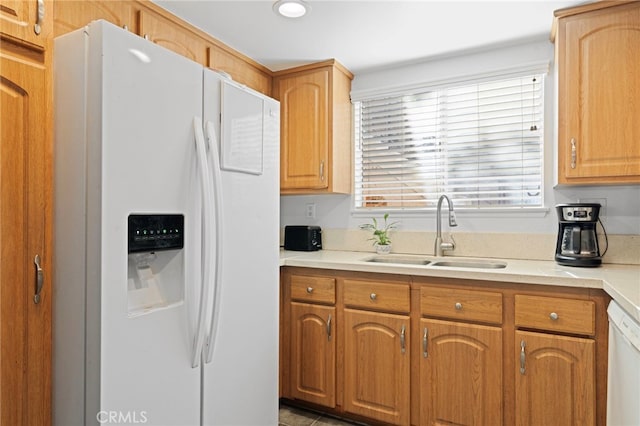 kitchen featuring white appliances and sink