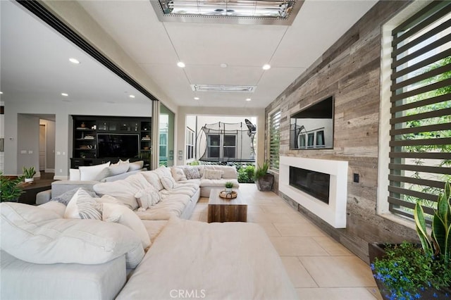 living room with built in features and light tile patterned floors