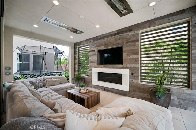 living room with plenty of natural light and light tile patterned floors