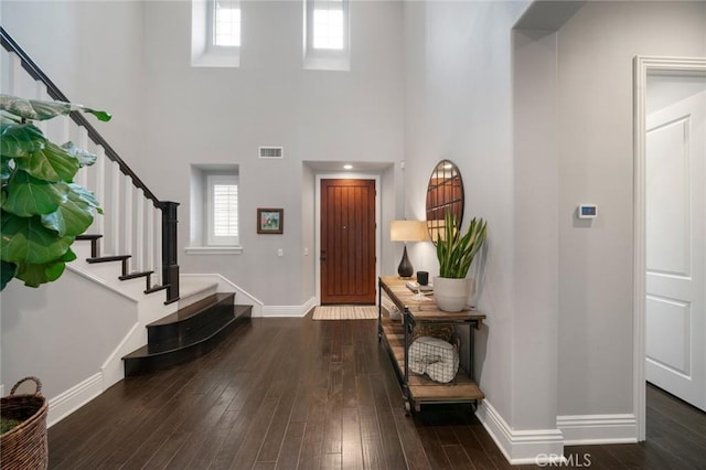 entrance foyer with a high ceiling and dark hardwood / wood-style flooring