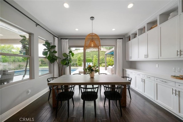 dining area with dark hardwood / wood-style flooring