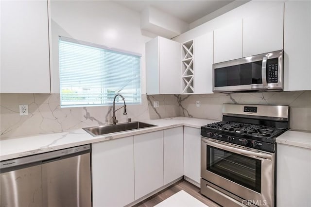 kitchen featuring white cabinetry, sink, and stainless steel appliances