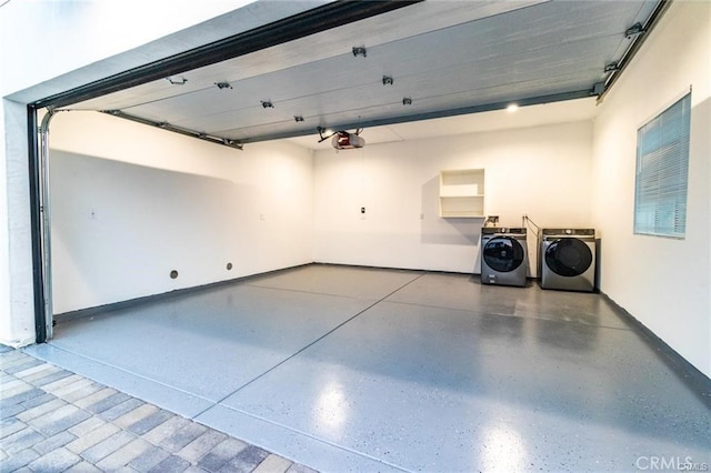 garage featuring washing machine and dryer and a garage door opener