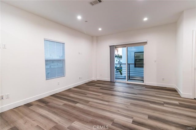 empty room with hardwood / wood-style floors