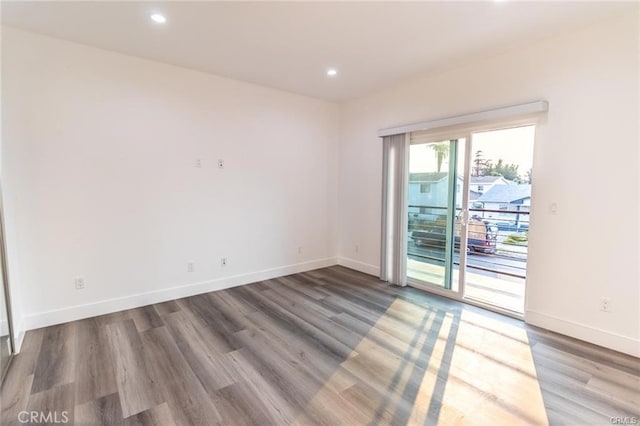 unfurnished room with hardwood / wood-style floors