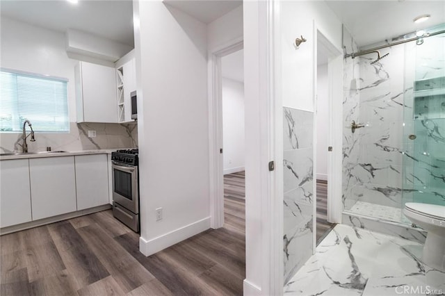 bathroom featuring hardwood / wood-style floors, vanity, and a shower with door