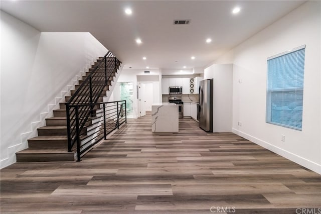 kitchen with white cabinetry, dark hardwood / wood-style flooring, and stainless steel appliances