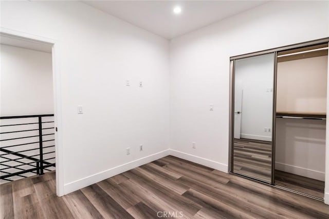 unfurnished room with dark wood-type flooring