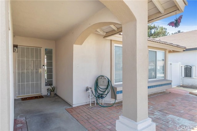 property entrance featuring a patio area