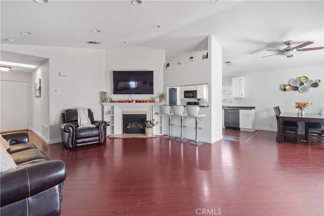 living room with ceiling fan and wood-type flooring