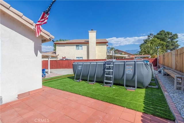 exterior space with a patio and an empty pool