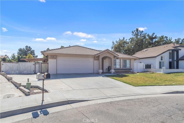 view of front of house with a front yard and a garage