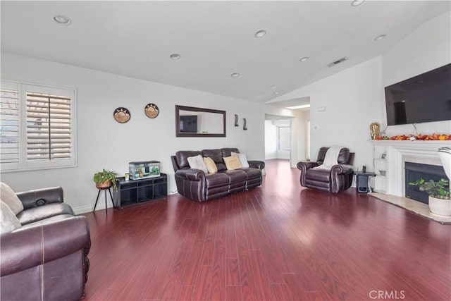 living room with wood-type flooring and lofted ceiling