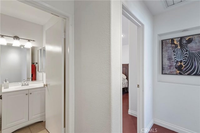 bathroom with tile patterned flooring and vanity