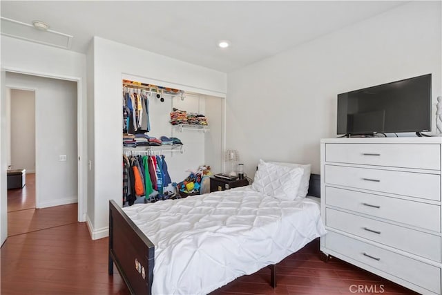 bedroom featuring a closet and dark hardwood / wood-style floors